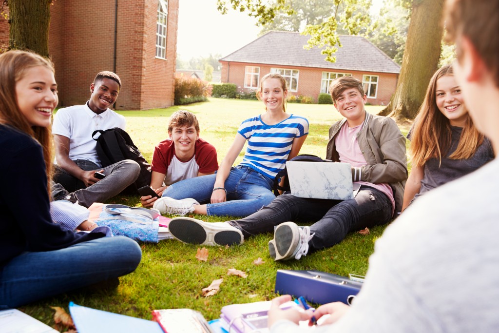 Teenagers sitting on school grounds