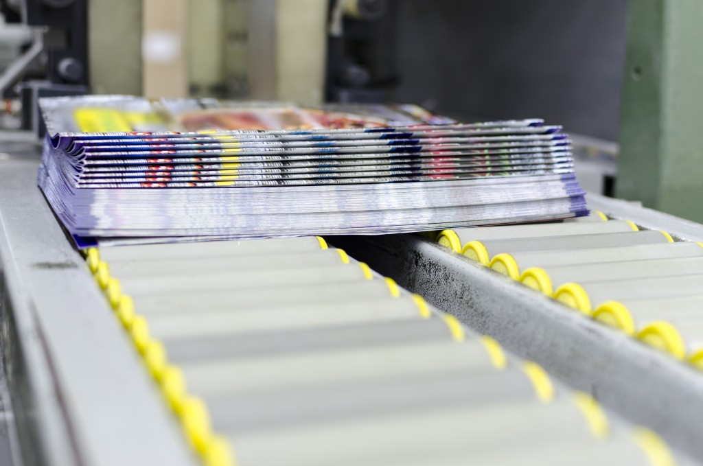 set of brochures being printed in a factory