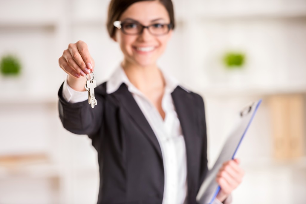 Property manager holding a key and clipboard