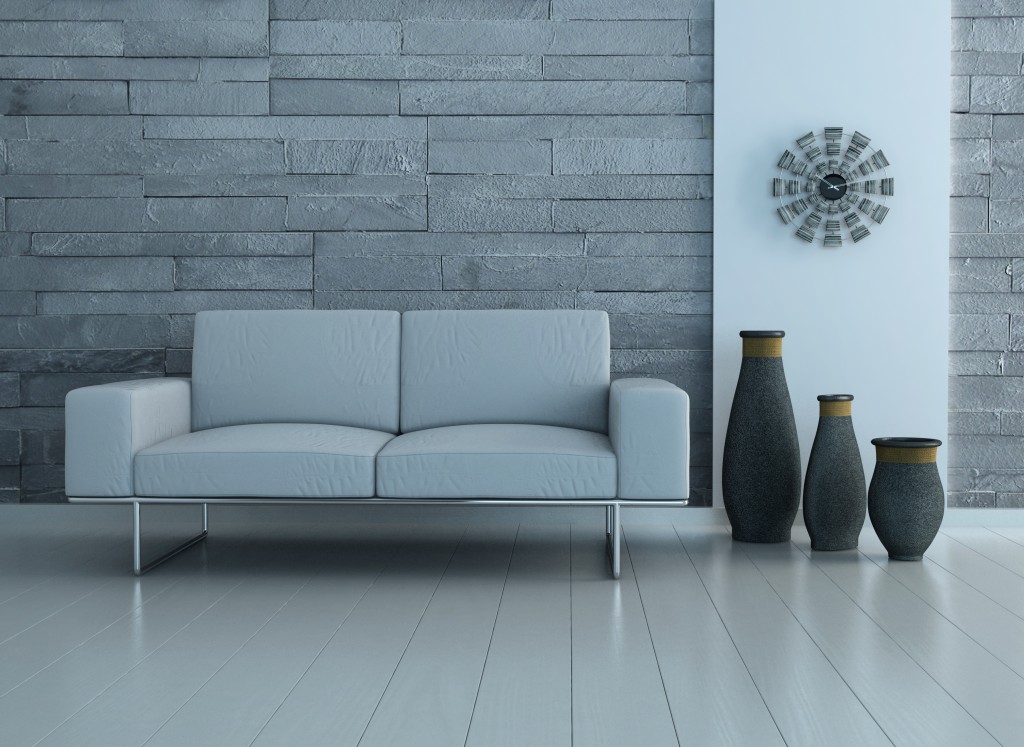 gray wall panelling with a gray couch and three big vases