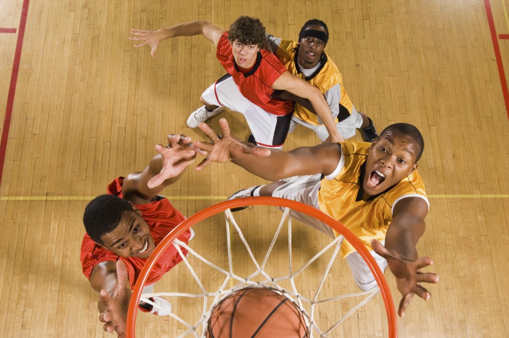 Basketball players fighting for the ball