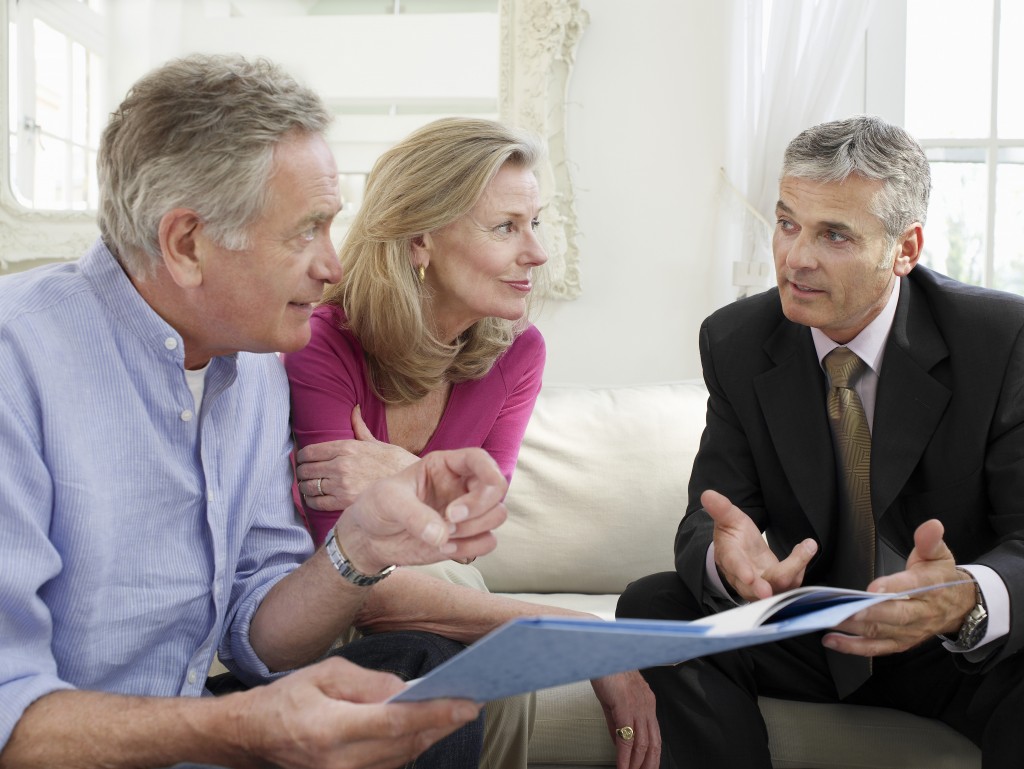 Mature couple talking to a retirement planner