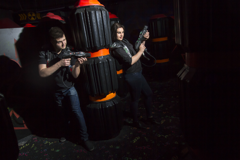 Couple playing laser tag