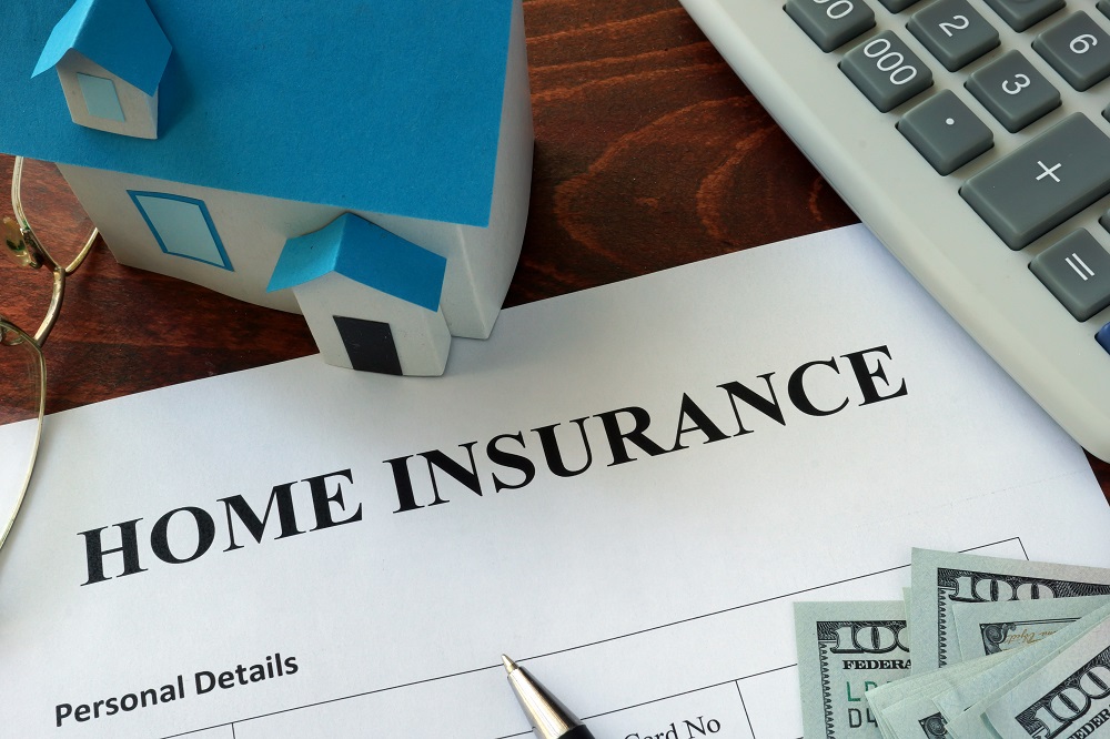 Home insurance form and dollars on the table.